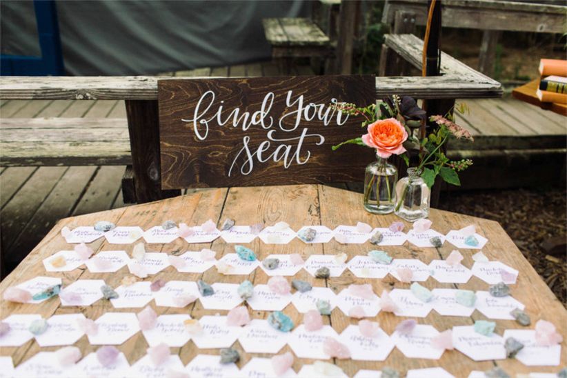 table with wedding escort cards and "find your seat" sign