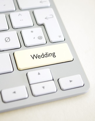 apple coputer with a wedding key on keyboard