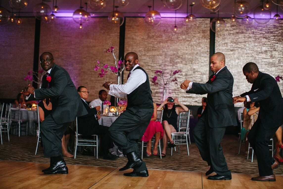 Groom dancing with groomsmen at the wedding.